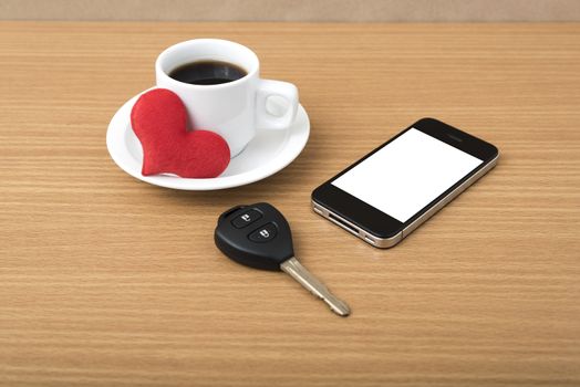 coffee phone car key and heart on wood table background