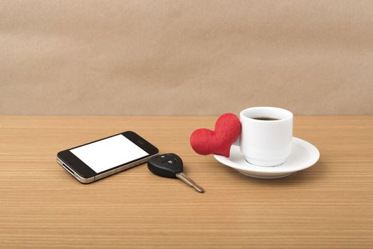 coffee phone car key and heart on wood table background