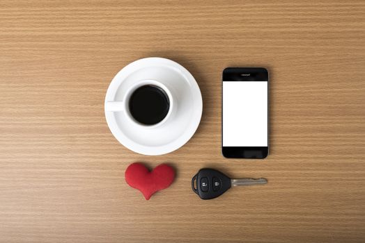 coffee phone car key and heart on wood table background