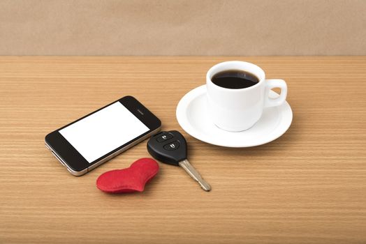 coffee phone car key and heart on wood table background