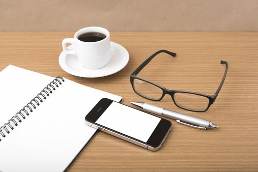 coffee,phone,notepad and eyeglasses on wood table background