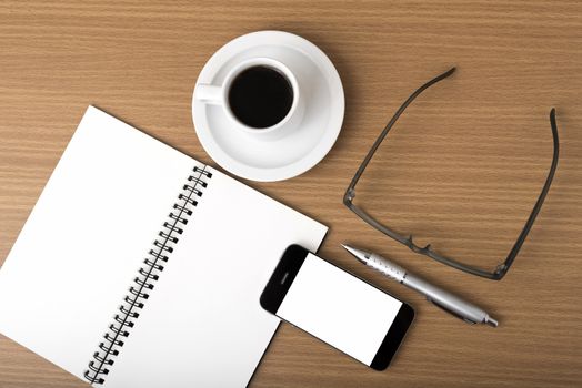 coffee,phone,notepad and eyeglasses on wood table background