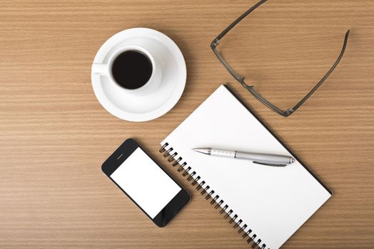 coffee,phone,notepad and eyeglasses on wood table background