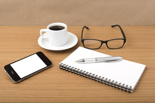coffee,phone,notepad and eyeglasses on wood table background