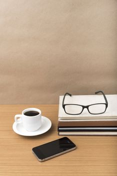 coffee,phone,stack of book and eyeglasses on wood table background