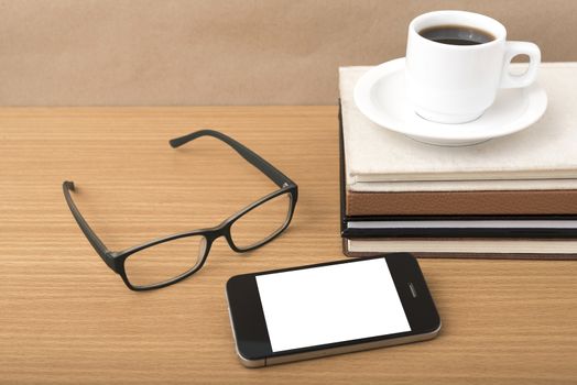 coffee,phone,stack of book and eyeglasses on wood table background