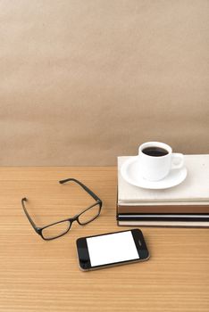 coffee,phone,stack of book and eyeglasses on wood table background