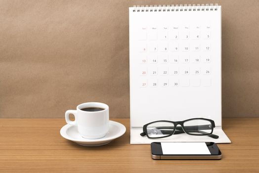 coffee,phone,eyeglasses and calendar on wood table background