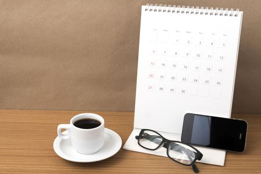 coffee,phone,eyeglasses and calendar on wood table background