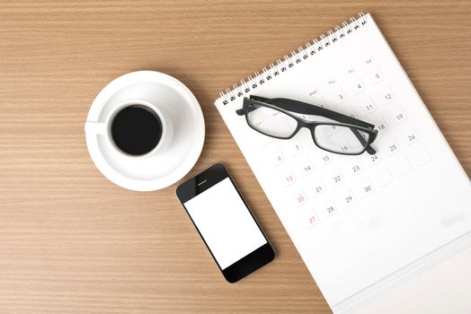 coffee,phone,eyeglasses and calendar on wood table background