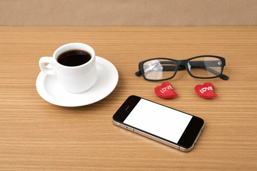 coffee,phone,eyeglasses and heart on wood table background