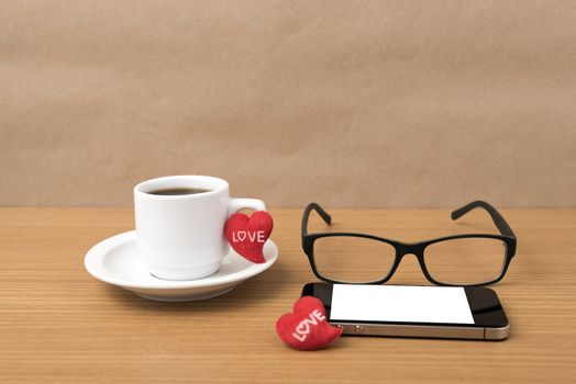 coffee,phone,eyeglasses and heart on wood table background