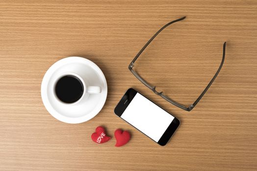 coffee,phone,eyeglasses and heart on wood table background