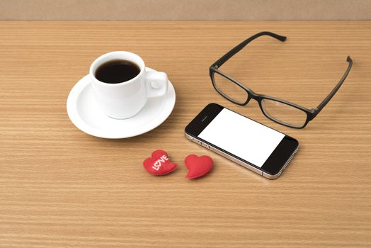 coffee,phone,eyeglasses and heart on wood table background