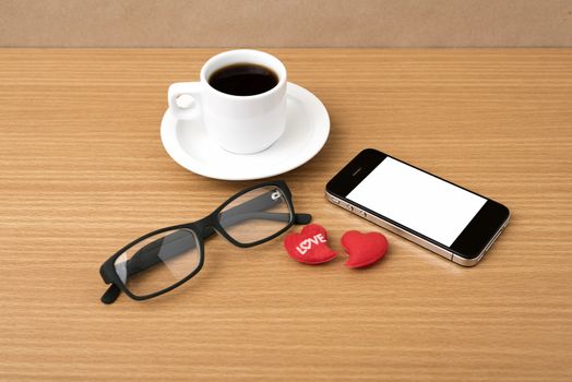 coffee,phone,eyeglasses and heart on wood table background