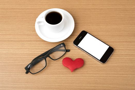 coffee,phone,eyeglasses and heart on wood table background