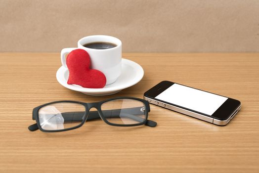 coffee,phone,eyeglasses and heart on wood table background