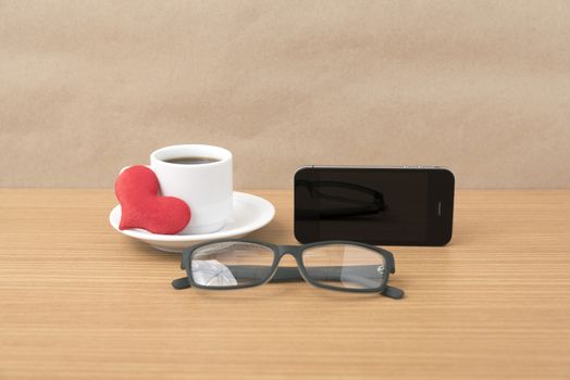 coffee,phone,eyeglasses and heart on wood table background