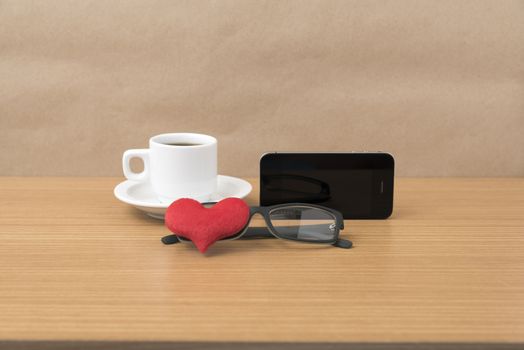 coffee,phone,eyeglasses and heart on wood table background