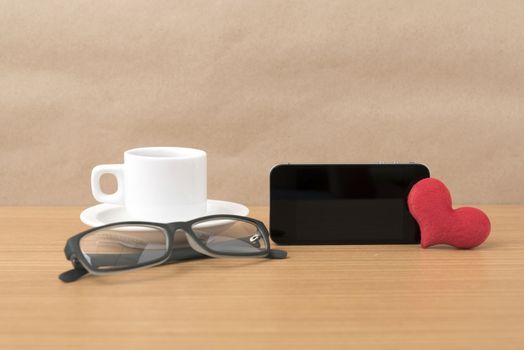coffee,phone,eyeglasses and heart on wood table background