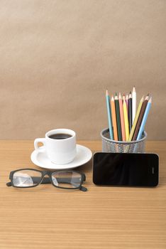 coffee,phone,eyeglasses and pencil on wood table background