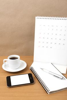 coffee,phone,notepad and calendar on wood table background