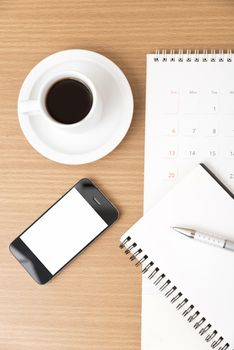 coffee,phone,notepad and calendar on wood table background