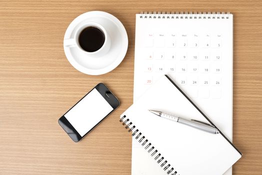 coffee,phone,notepad and calendar on wood table background