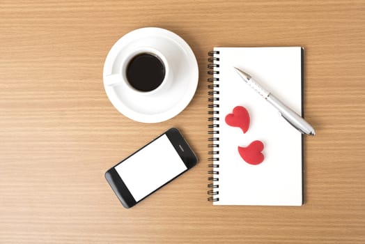 coffee,phone,notepad and heart on wood table background