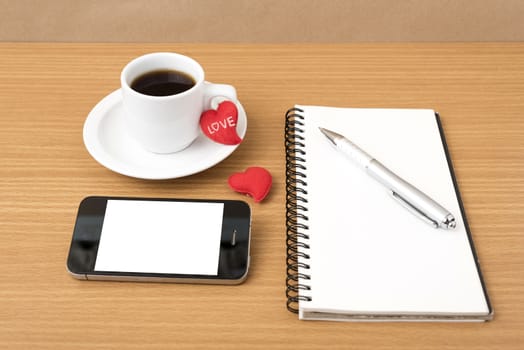coffee,phone,notepad and heart on wood table background