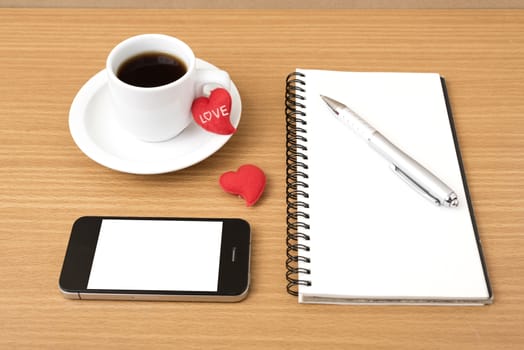 coffee,phone,notepad and heart on wood table background