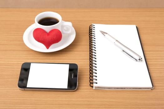 coffee,phone,notepad and heart on wood table background