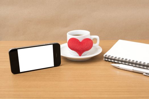 coffee,phone,notepad and heart on wood table background