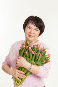 the beautiful mature woman with a bouquet of tulips
