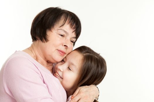 the beautiful mature woman embraces the granddaughter