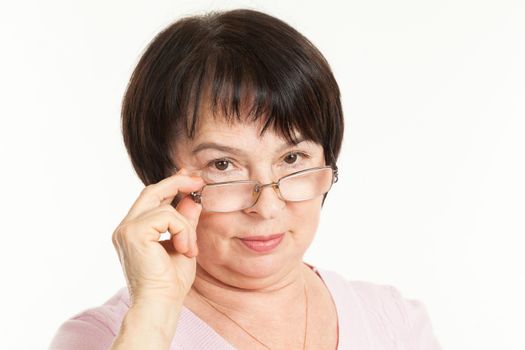 the beautiful mature woman with a severe look wearing spectacles