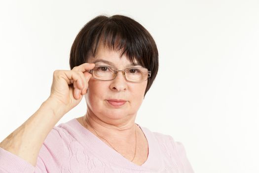 the beautiful mature woman with a severe look wearing spectacles