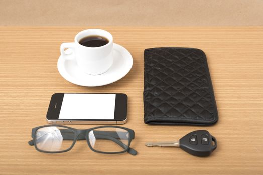 coffee,phone,car key,eyeglasses and wallet on wood table background