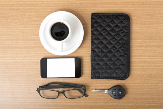 coffee,phone,car key,eyeglasses and wallet on wood table background