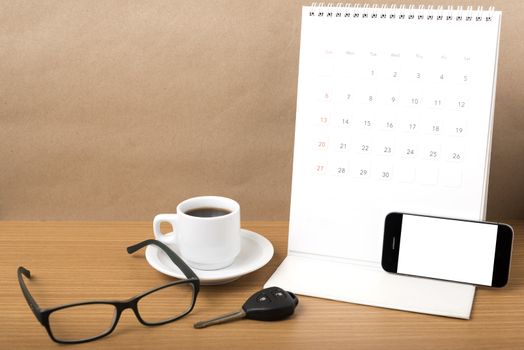 coffee,phone,car key,eyeglasses and calendar on wood table background