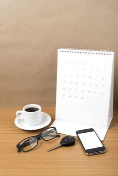 coffee,phone,car key,eyeglasses and calendar on wood table background