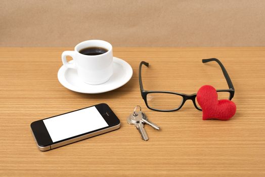 coffee,phone,eyeglasses,key and heart on wood table background