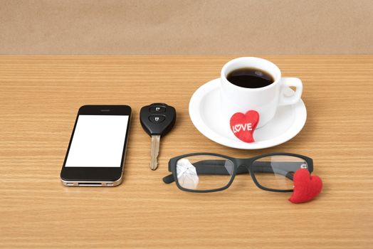 coffee,phone,eyeglasses,car key and heart on wood table background