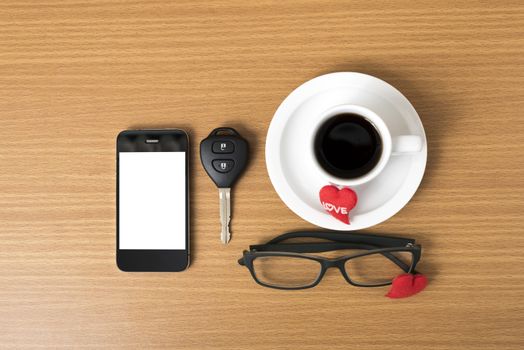 coffee,phone,eyeglasses,car key and heart on wood table background