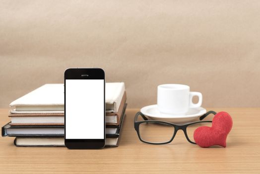coffee,phone,eyeglasses,stack of book and heart on wood table background