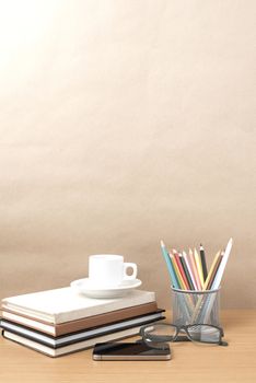 coffee,phone,eyeglasses,stack of book and color pencil on wood table background