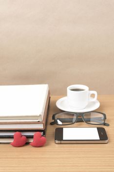 coffee,phone,eyeglasses,stack of book and heart on wood table background