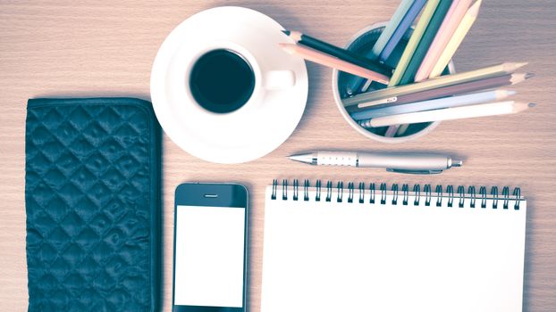 coffee,phone,eyeglasses,notepad,wallet and color pencil on wood table background vintage style
