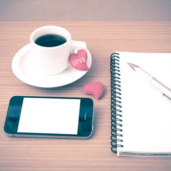 coffee,phone,notepad and heart on wood table background vintage style