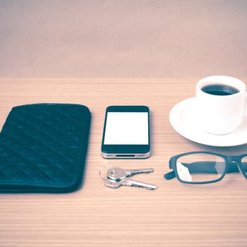 coffee,phone,key,eyeglasses and wallet on wood table background vintage style